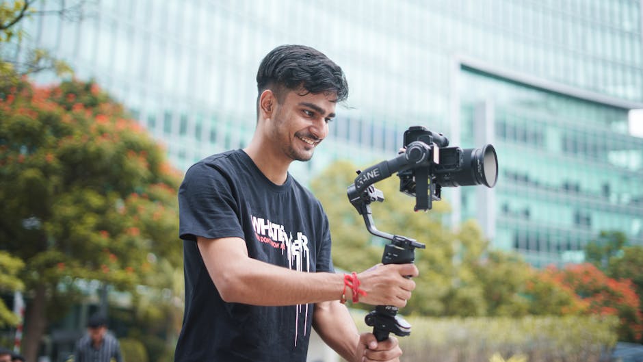 Professional wedding videographer smiling with cinema camera